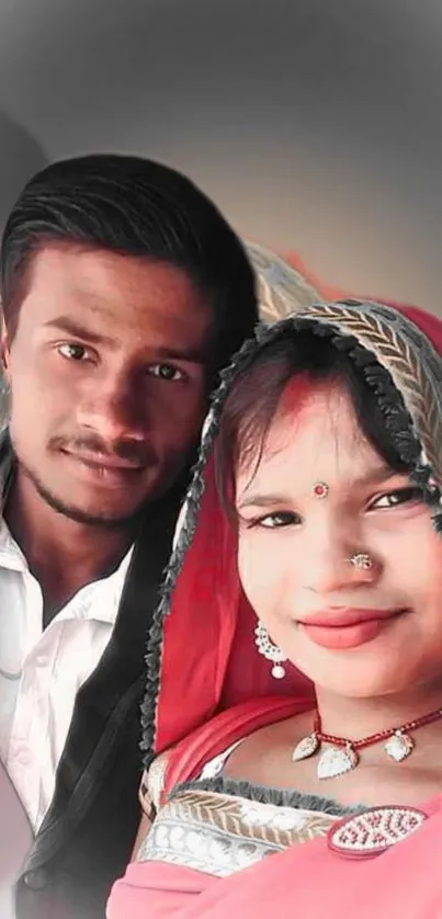 A couple in traditional attire posing happily for a portrait.