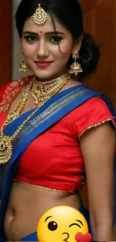 Woman in vibrant traditional red saree with gold jewelry.