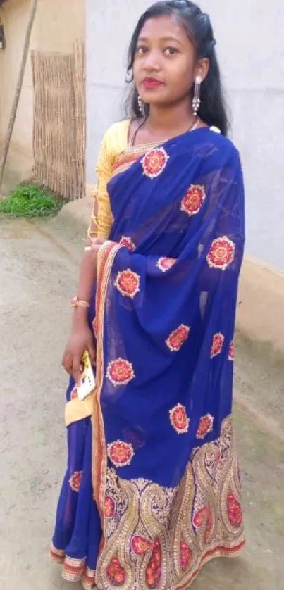 Woman in vibrant blue traditional saree.