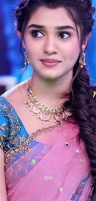 Woman in a pink saree with intricate jewelry and braided hairstyle.