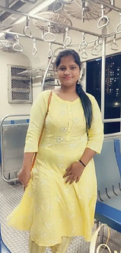 Woman in yellow dress on a train with city view.