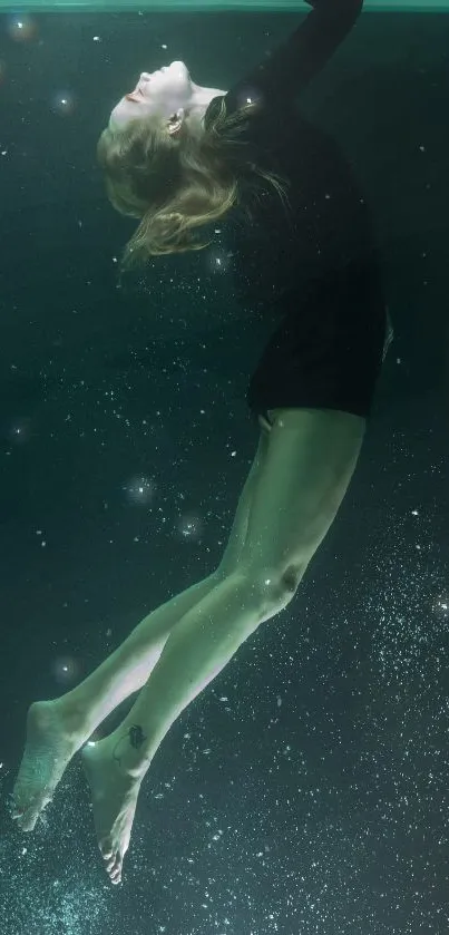 Woman elegantly floating underwater in teal ambiance.