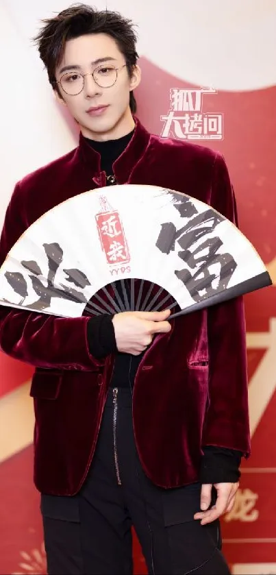 Person in velvet jacket holding fan on red background.