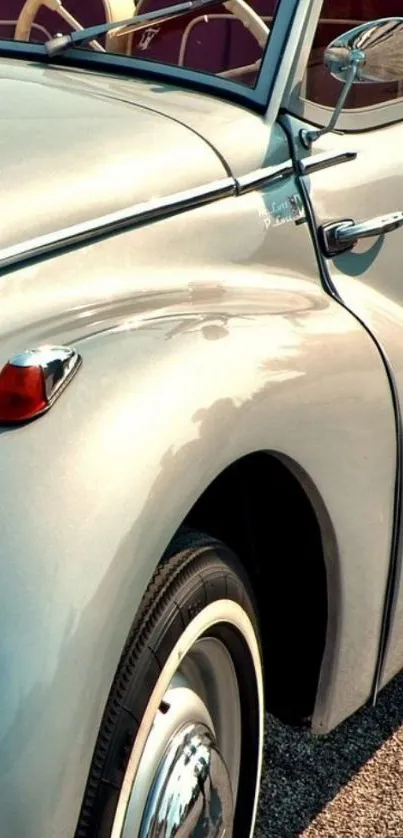 Vintage car with chrome details in a sunny setting.