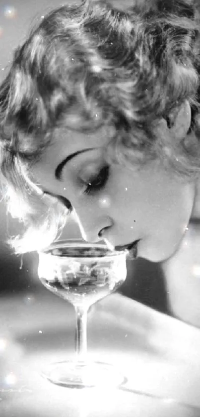 Vintage woman smiling while sipping champagne in elegant black & white photo.