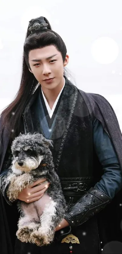 An elegant warrior in dark clothes holding a puppy by the beach.