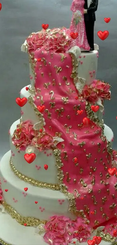 Elegant wedding cake with pink floral decorations and topper.