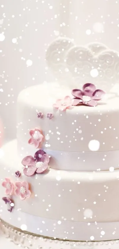 Elegant white wedding cake with floral accents and heart topper.
