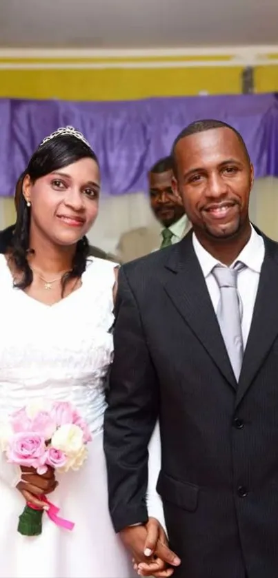 Happy couple in wedding attire with purple decor background.