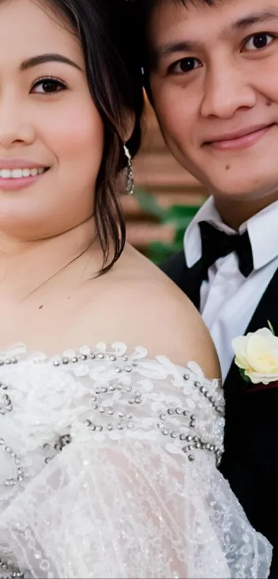 Elegant wedding couple with white attire smiling together.