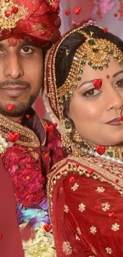 Wedding couple in traditional attire with red hearts.