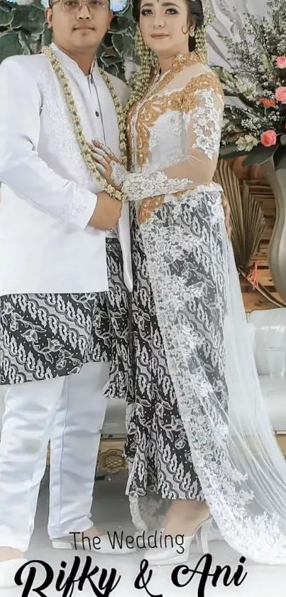 Wedding couple in elegant traditional attire with floral decorations.