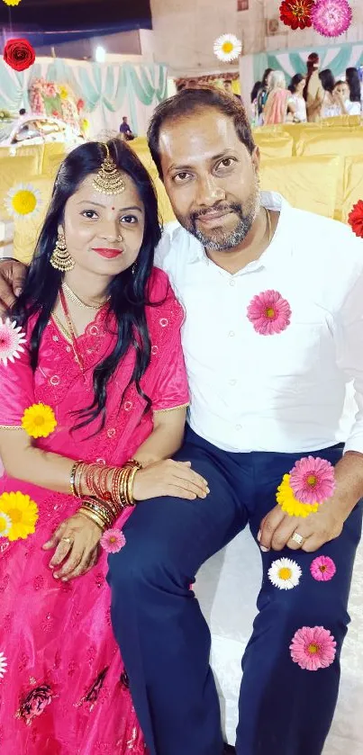 Wedding couple sitting elegantly at a vibrant festive event with traditional attire.