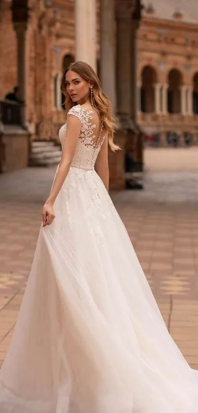 Bride in elegant lace wedding dress at historic plaza.