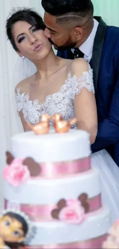 Bride and groom kissing by a wedding cake.