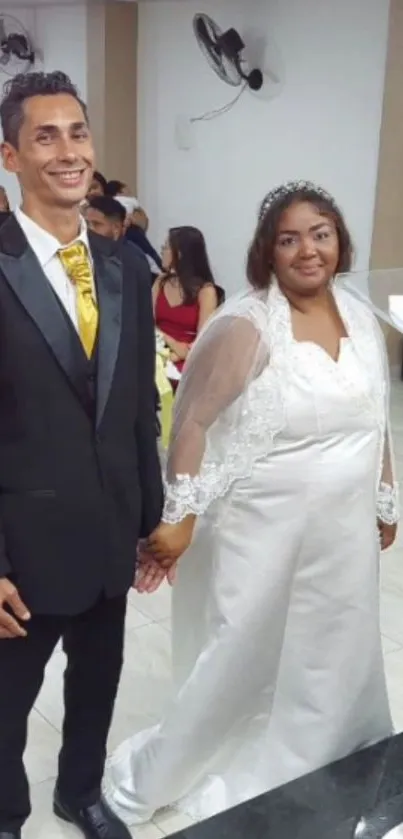 Wedding couple in formal attire, bride in white dress with veil.