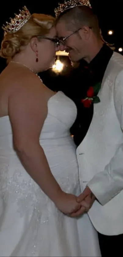 Elegant wedding couple holding hands under glowing lights.