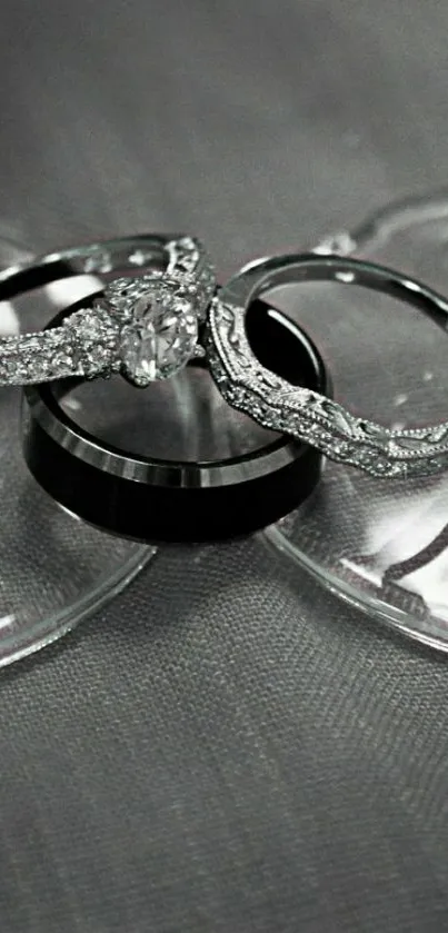 Elegant wedding rings arranged on a textured gray background.