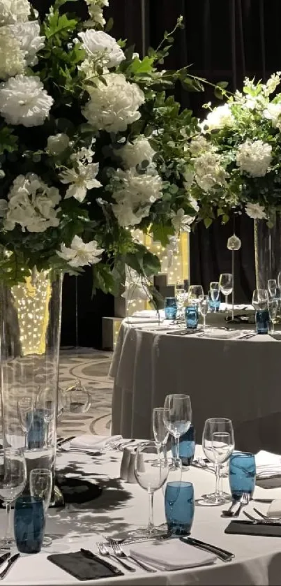 Elegant wedding table setup with floral centerpieces.