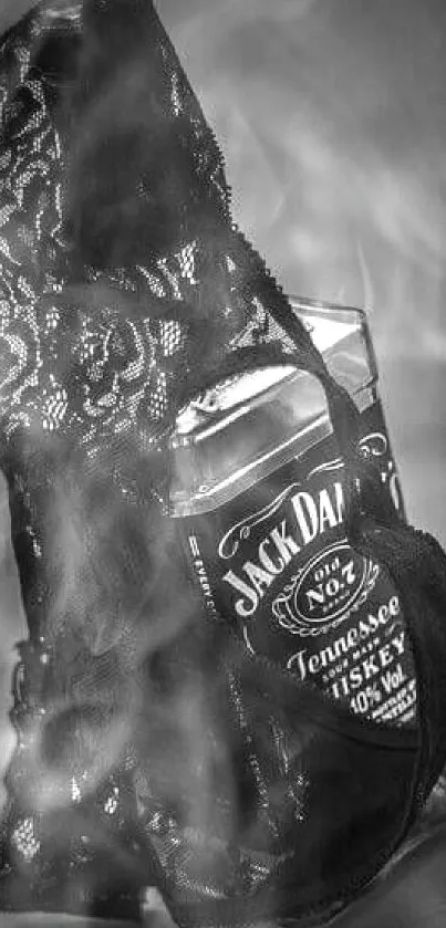 Whiskey bottle wrapped in black lace, artistic black and white wallpaper.