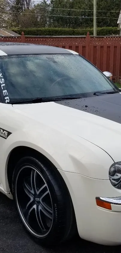 Chrysler Hemi car with rain-dappled surface in a driveway.