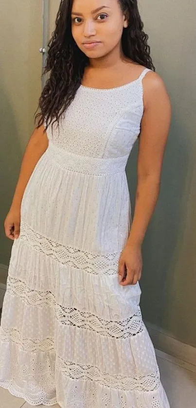 Woman in an elegant white dress posing for a mobile wallpaper.