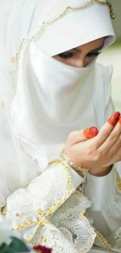 Woman wearing a white hijab, praying silently.