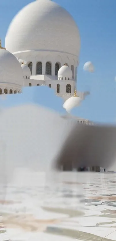 Majestic white mosque against clear blue sky.