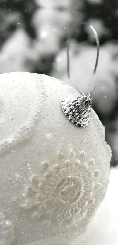 Intricate white ornament with snowy background, perfect for festive decor.