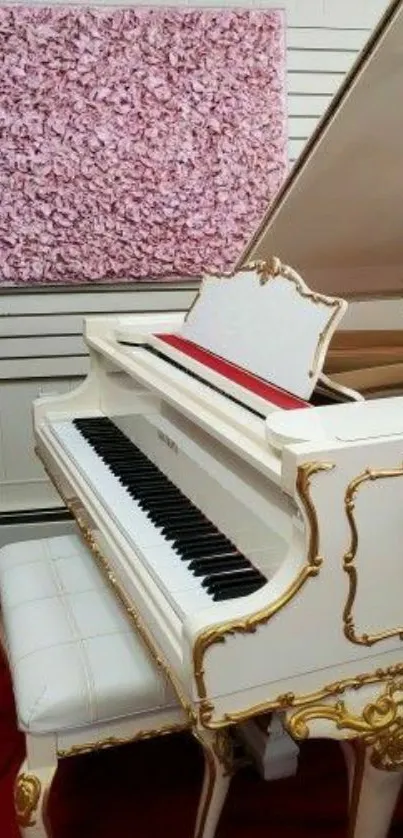 Luxurious white piano with gold accents against pink art backdrop.