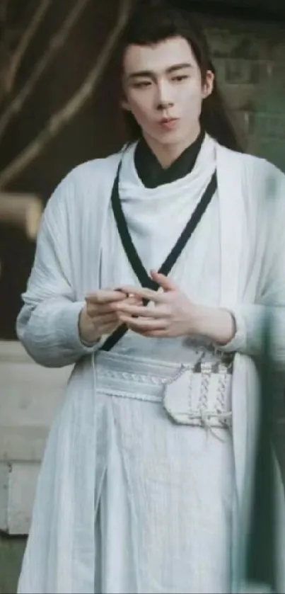 Figure in traditional white robes standing calmly.