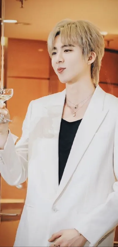 Stylish individual in a white suit holding a glass, perfect mobile wallpaper.