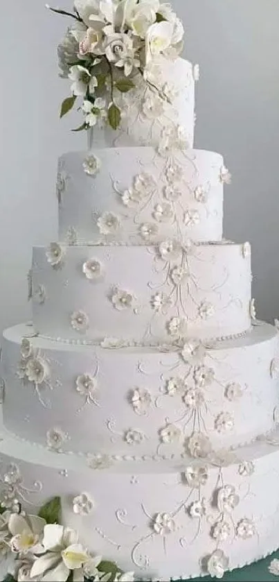 Elegant white wedding cake with floral accents.