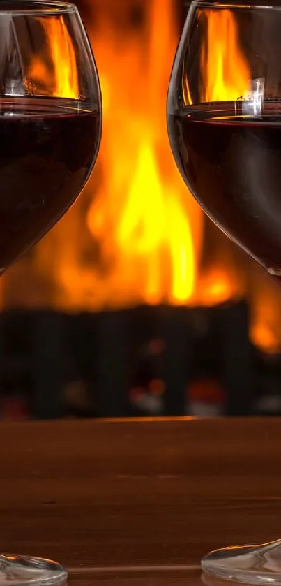 Two wine glasses in front of a warm, glowing fireplace.