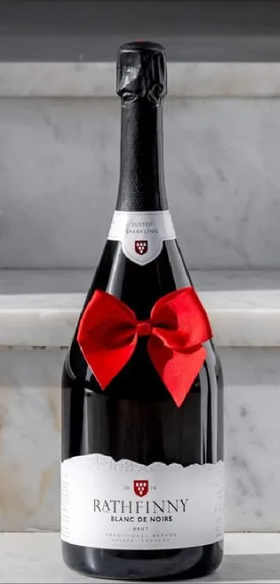 Elegant wine bottle with red bow on marble steps.