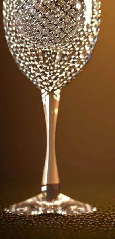 Elegant wine glass with crystals on a warm, golden background.