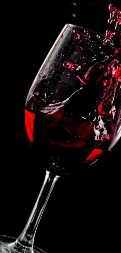 Elegant splash of red wine against a black background.