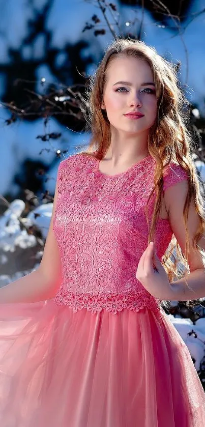 Woman in pink dress in snowy landscape, elegant beauty.