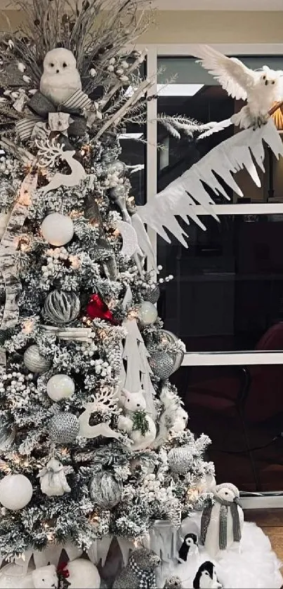 Beautifully decorated Christmas tree with winter-themed ornaments.