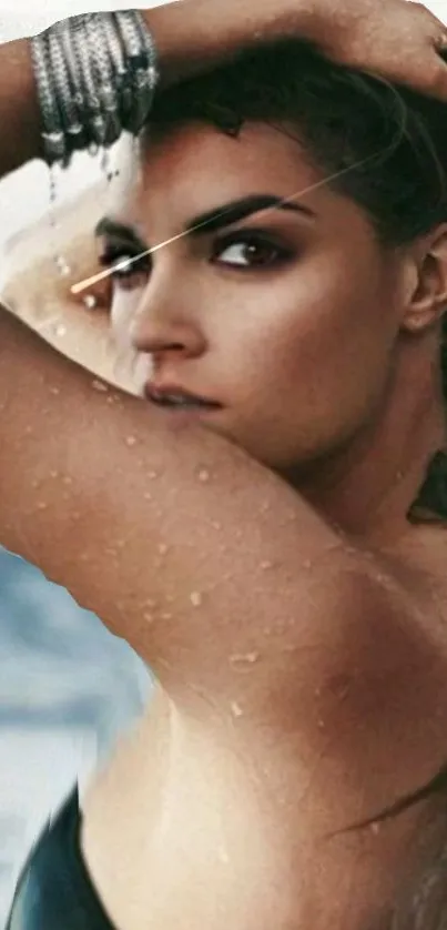 Elegant woman posing on a beach with wet hair and bracelets.