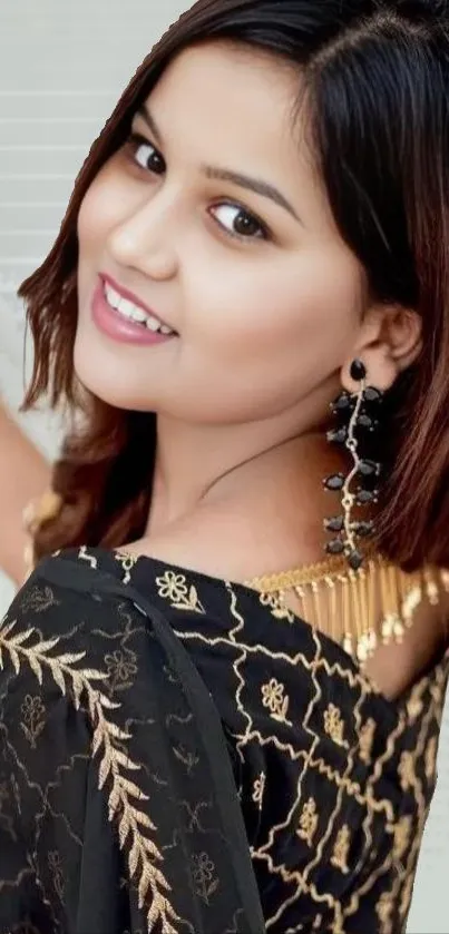 Stylish woman in black and gold attire portrait with earrings.