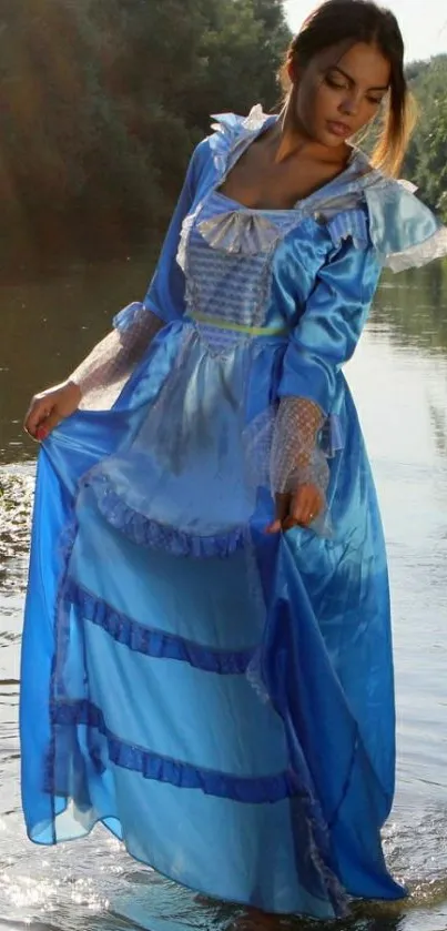 Woman in elegant blue dress standing in river.