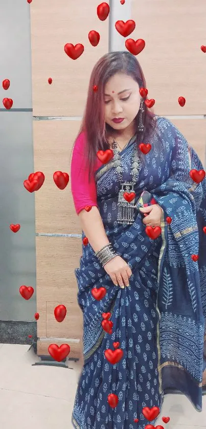 Elegant woman in a blue saree with red heart accents.