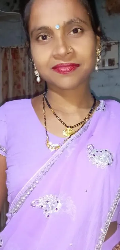 Woman in a lavender sari with a vibrant style.