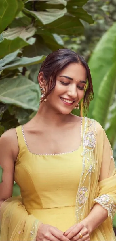 Woman in yellow dress surrounded by green leaves.