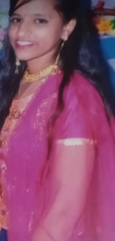 Woman in deep pink traditional attire with long hair and accessories.