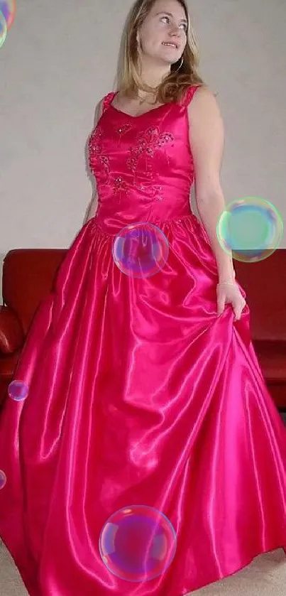 Woman in a stunning pink gown posing elegantly.