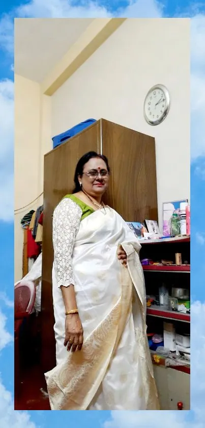 Elegant woman in a white saree with a sky blue background.