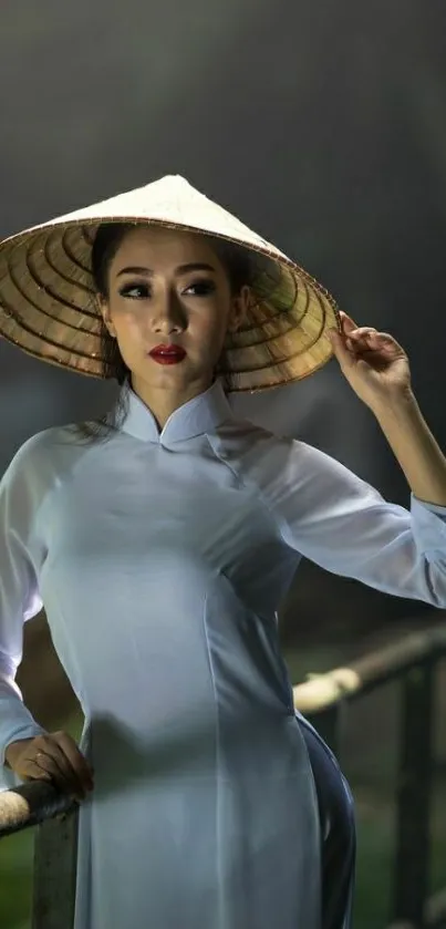 Elegant woman in a white dress with a traditional Vietnamese hat.