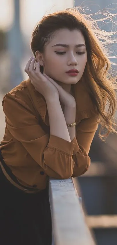 Elegant woman leaning on a metal rail in a stylish outfit.